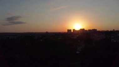 Aerial sunset landing timelapse footage of summer Kharkiv city center residential and park area in contrast sunlight