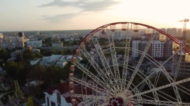 Ferris wheel spinning aerial top view in Kharkiv city center, amusement Gorky Park . High attraction for recreation and city observation
