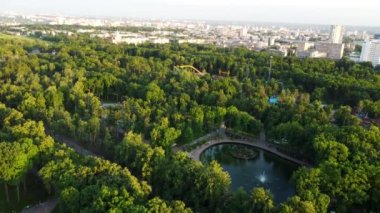 Attractions recreation area with greens in sunset light. Aerial evening view in Kharkiv city center Gorky Park