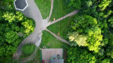 Cable car follow look down footage. Attraction station aerial view in green summer Kharkiv city popular recreation Central Park, Sarzhyn Yar