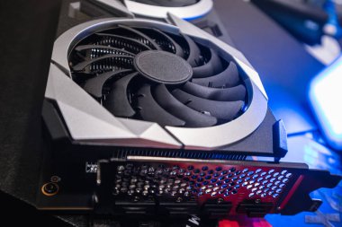 Gpu graphics video card cooler and ports panel close-up in blue light, PC hardware details. Components from powerful modern personal computer
