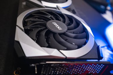 Kyiv, Ukraine - August 19, 2022: Cooler in blue light, MSI graphics card with AMD Radeon chipset, close-up with selective focus, dark design