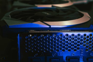 Kyiv, Ukraine - August 19, 2022: MSI MECH 2X graphics video card back ports metal panel and coolers in blue light, close-up