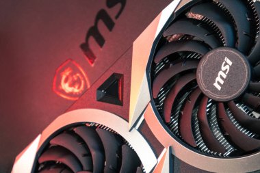 Kyiv, Ukraine - August 19, 2022: MSI MECH 2X graphics video card with AMD Radeon RX6700XT chipset in red light, close-up with selective focus