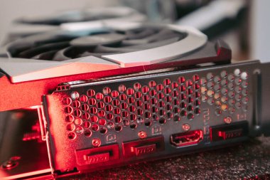 Kyiv, Ukraine - August 19, 2022: MSI graphics card ports panel, PC hardware details in red light. Components from personal computer