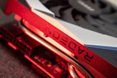 Kyiv, Ukraine - August 19, 2022: AMD Radeon RX6700XT chipset on MSI MECH 2X graphics card in red light, PC hardware details close-up with selective focus