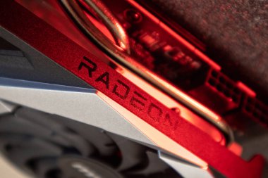 Kyiv, Ukraine - August 19, 2022: AMD Radeon chipset on MSI MECH 2X graphics card side view in red light, PC hardware details