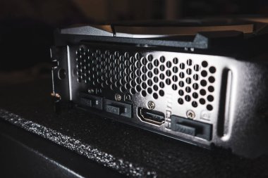 Kyiv, Ukraine - August 19, 2022: MSI graphics card ports panel, PC hardware details in dark. Components from powerful modern personal computer