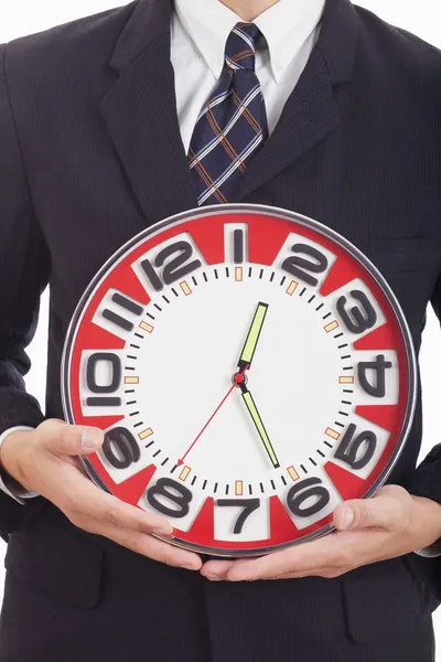 Businessman holding a clock in his hands — Stock Photo, Image