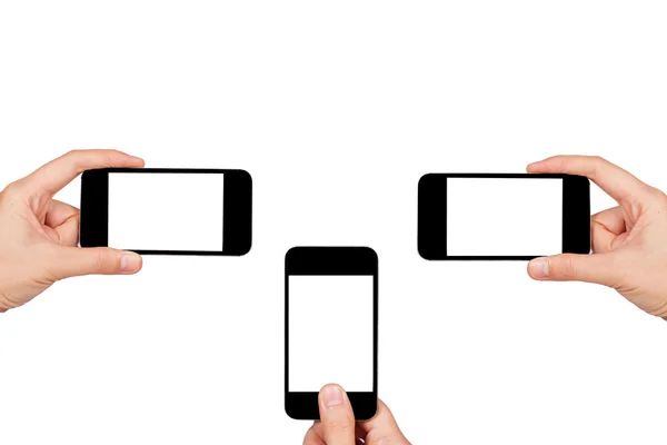 Trzy ręce trzyma trzy smartfony — Zdjęcie stockowe
