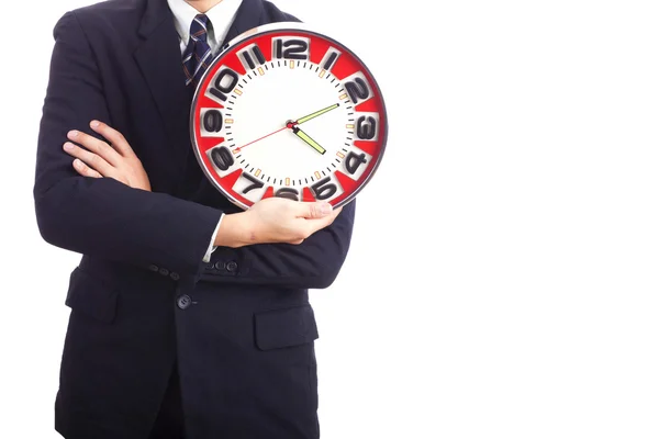 Empresário segurando um grande relógio vermelho — Fotografia de Stock