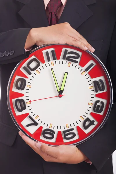 Man holding a big red clock — Stock Photo, Image