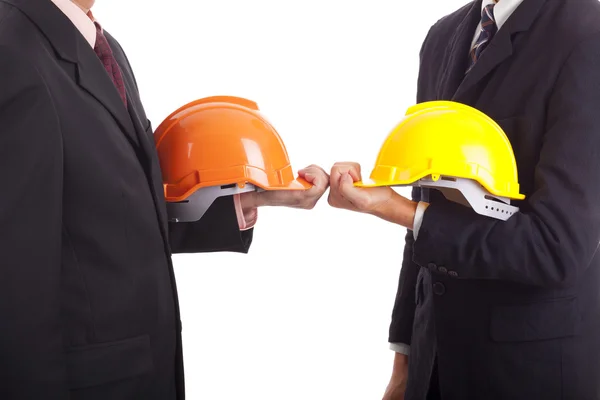 Construction engineers are holding red and yellow hard hats — Stock Photo, Image