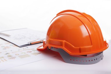 Red helmet lying on documents clipart