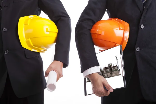 Construction engineers with helmets and documents — Stock Photo, Image