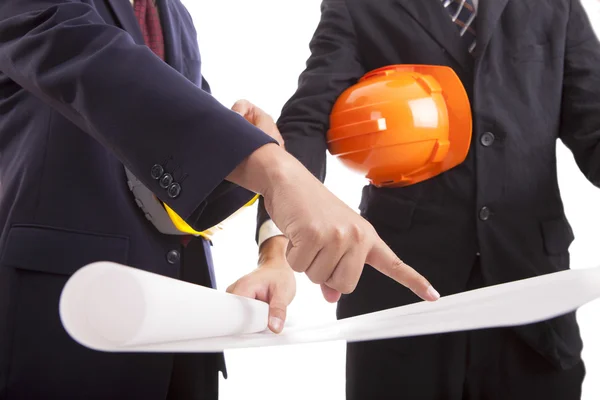 Construction engineer with helmets considering a draft — Stock Photo, Image