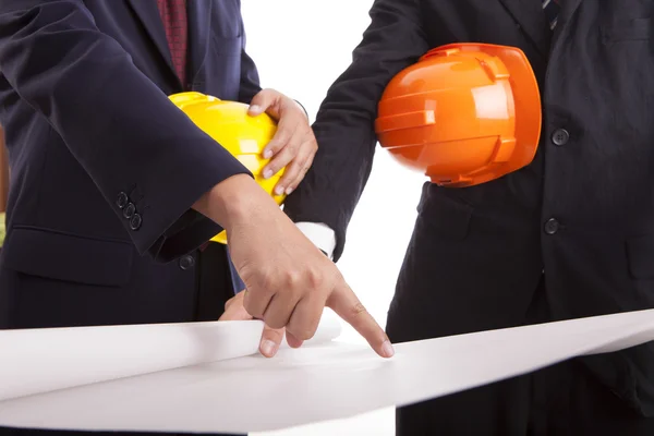 Construction engineer with helmets considering a draft — Stock Photo, Image