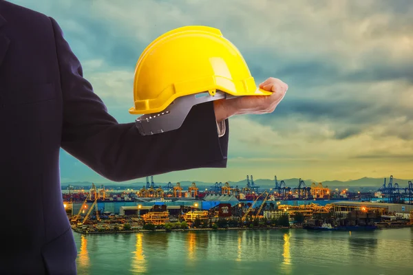 Construction engineer holding a yellow hard hat — Stock Photo, Image