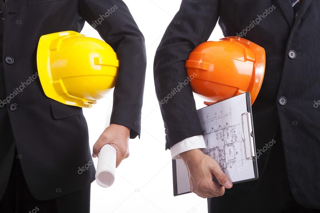 Construction engineers with helmets and documents