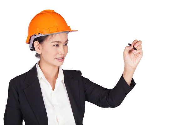 उसके सिर पर एक नारंगी हेलमेट के साथ महिला इंजीनियर दीवार पर लिखती है — स्टॉक फ़ोटो, इमेज
