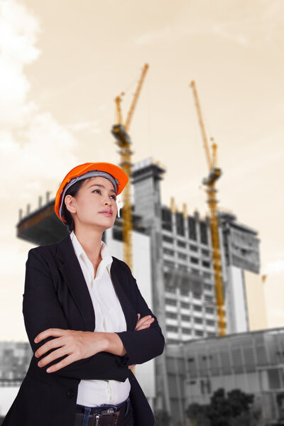 Woman engineer standing on the building background
