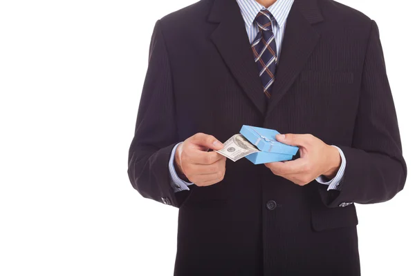 Businessman holding a gift box with money — Stock Photo, Image