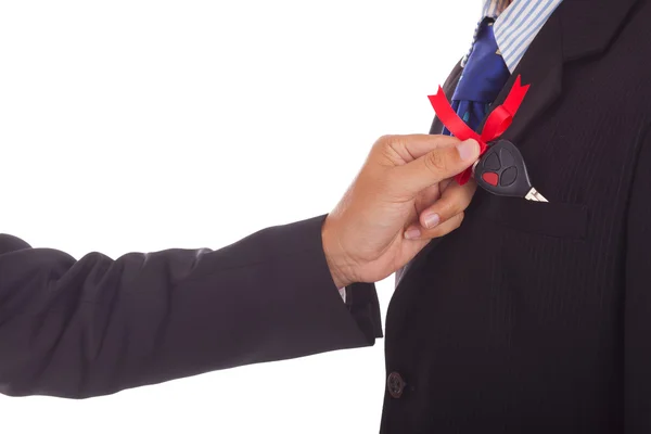 Businessman lays down in the pocket to another businessman car keys — Stock Photo, Image