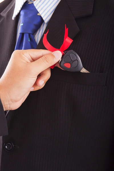 Businessman lays down in the pocket to another businessman car keys — Stock Photo, Image