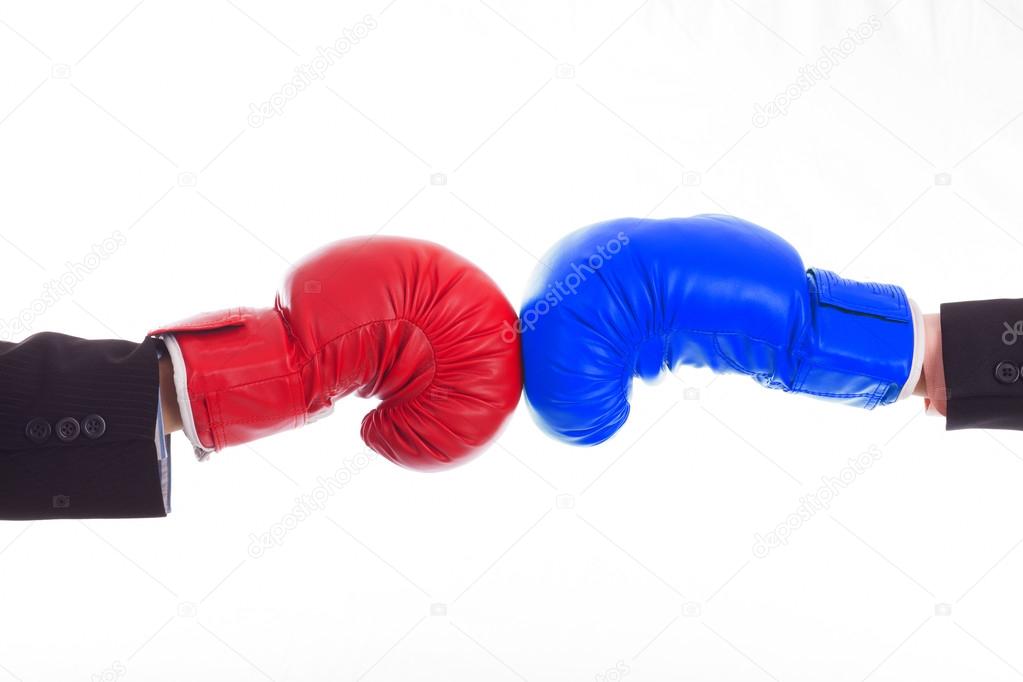 Two hands in the blue and red boxing gloves