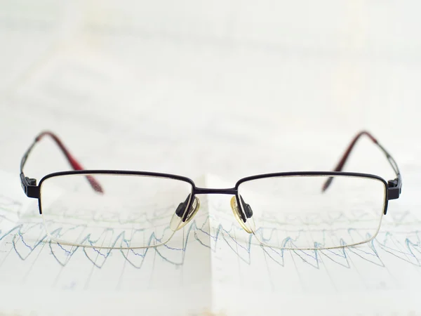 Glasses on scientific graph to analysis the results — Stock Photo, Image