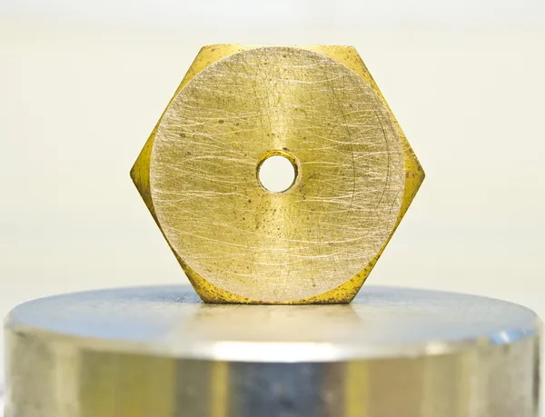 Hexagonal nut made of brass — Stock Photo, Image