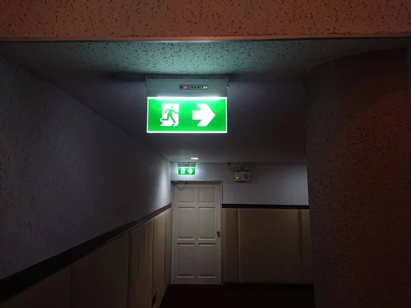 emergency exit sign in case of fire, glowing in the dark by electric lightin