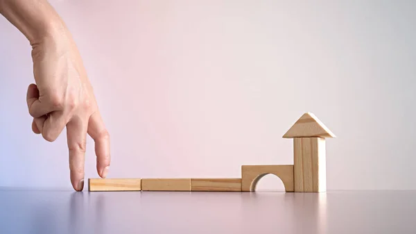 Conceptual Businessman Arranging Wooden Blocks Position House Shape Indicating His — Stock Photo, Image