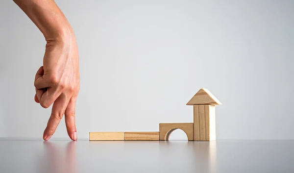 Conceptual Businessman Arranging Wooden Blocks Position House Shape Indicating His — Stock Photo, Image