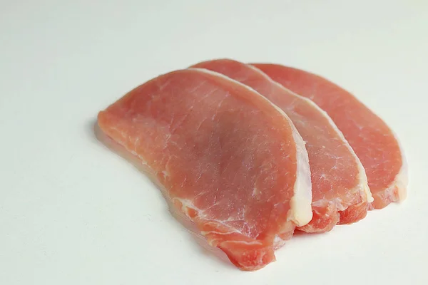  Beyaz arka planda baharatlı dilimlenmiş çiğ et.