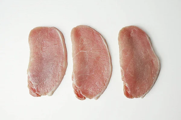  Beyaz arka planda baharatlı dilimlenmiş çiğ et.