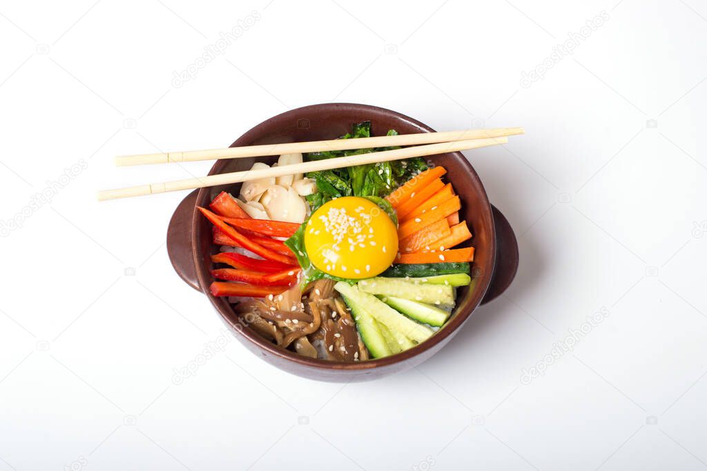 Korean rice dish Bibimbap. Usually served as a bowl of warm white rice topped with vegetables and egg. Top view