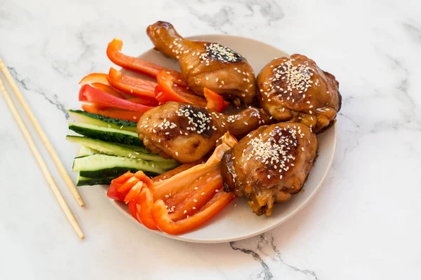 spicy chicken in sweet and sour sauce with chili pepper. teriyaki chicken's with sesame seeds. Chinese cuisine, Thai cuisine. Japanese food, copy space, recipe background
