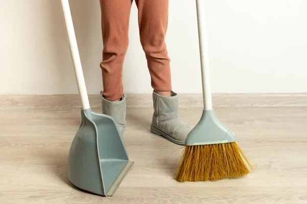 Clean up after repairs. Sweep up construction debris with a brush in a dustpan. Sweeping at home. Tools for cleaning the house. Make home repairs. The dust and debris after the renovation.