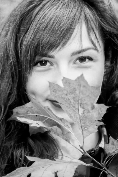 Pretty girl with autumn leaf — Stock Photo, Image
