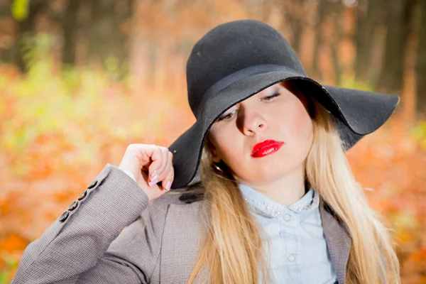 Beautiful girl in black hat — Stock Photo, Image
