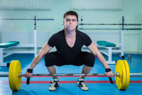 Sportsman pushing barbell — Stock Photo, Image