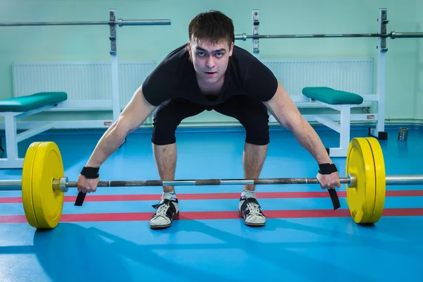 Sportsman pushing barbell — Stock Photo, Image