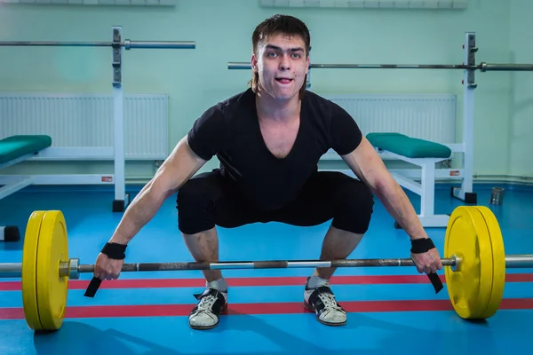 Sportsman pushing barbell — Stock Photo, Image