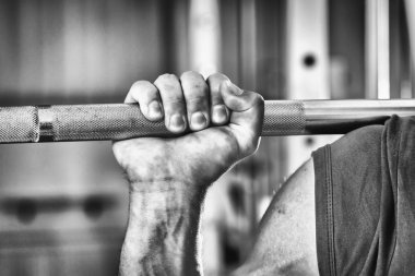 Sportsman's hand pushing barbell