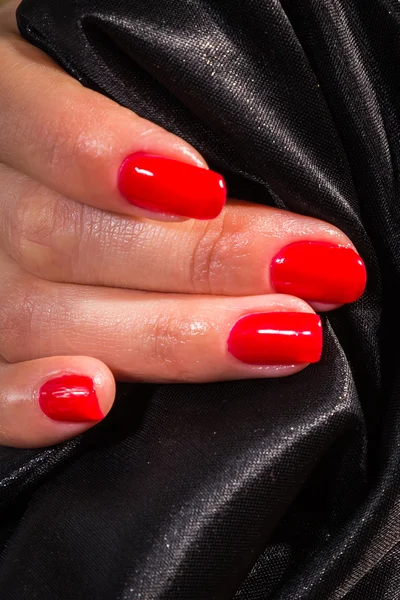 Beautiful female hands with red nail polish on the nails — Stock Photo, Image