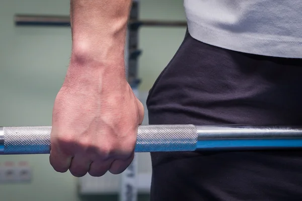 Hand holding barbell — Stock Photo, Image