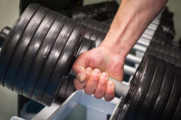 Man doing exercises with dumbbell — Stock Photo, Image