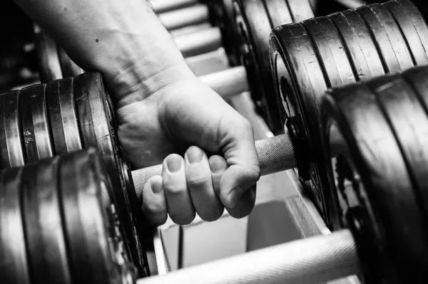 Man doing exercises with dumbbell — Stock Photo, Image