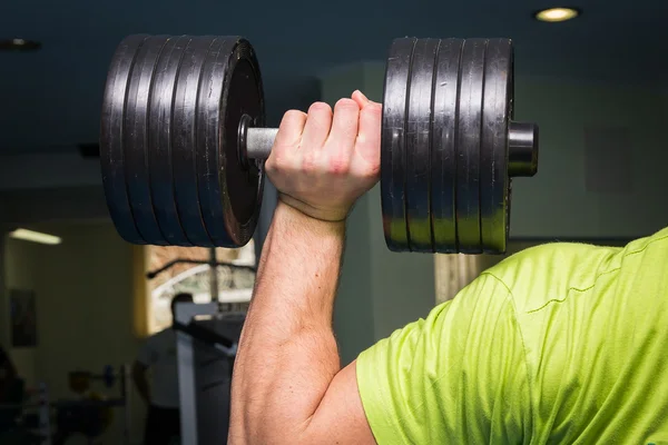 Man doing exercises with dumbbell — Stock Photo, Image
